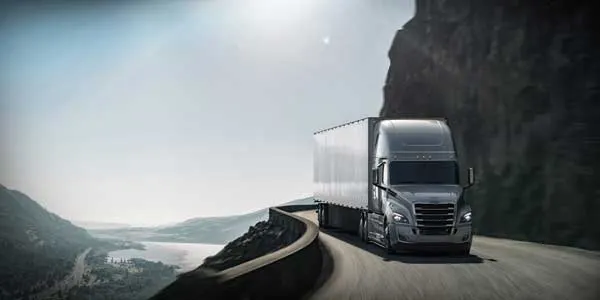 Cascadia tractor and trailer on a cliffside road
